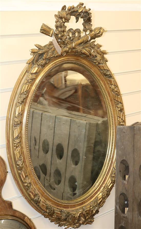 A Louis XVI style gilt oval mirror W.57cm